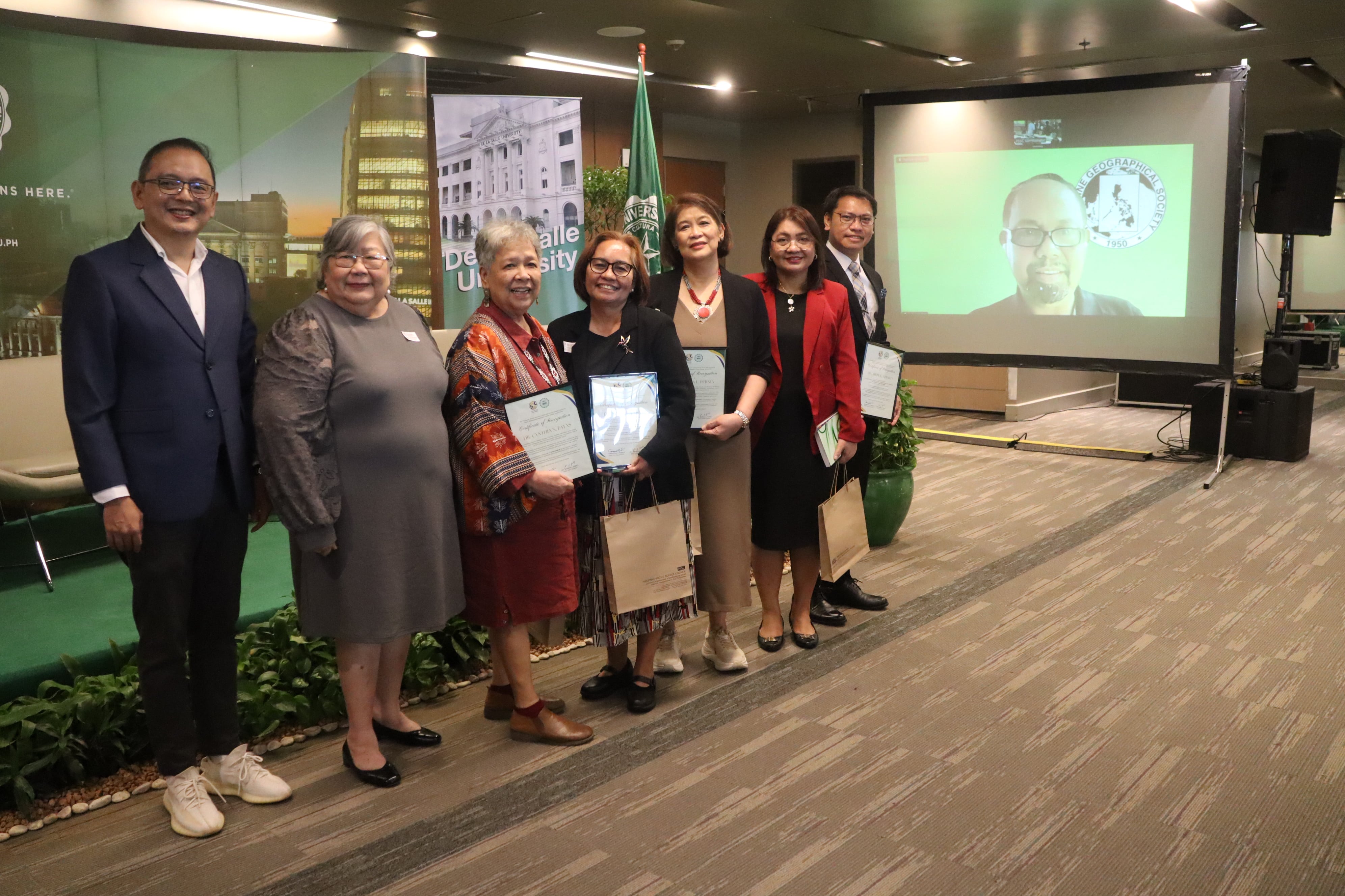 The hosts and panelists pose for a group photo during the awarding ceremony
