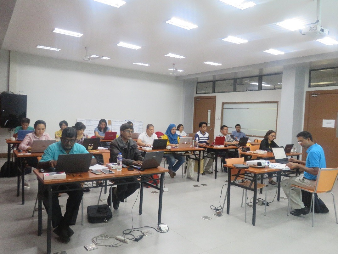 Trainers and participants focused on their machines